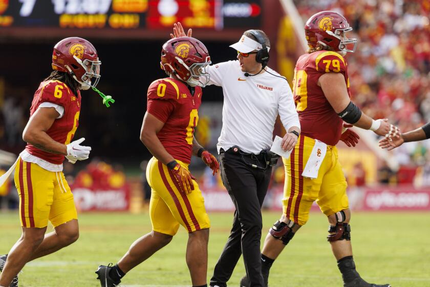 USC coach Lincoln Riley congratulates running back Quinten Joyner after his touchdown against Notre Dame on Nov. 30.