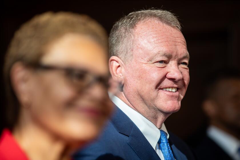 Los Angeles, CA - October 04: Jim McDonnell (R) speaks after being introduced by Mayor Karen Bass to serve as the new Chief LAPD during a press conference at City Hall Friday, Oct. 4, 2024 in Los Angeles, CA. (Ringo Chiu / For The Times)