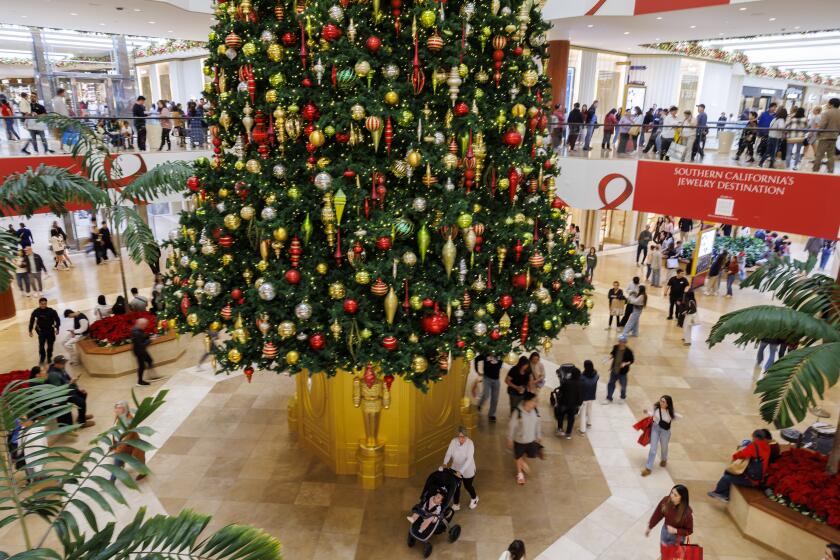 COSTA MESA, CA - NOVEMBER 29, 2024: The festive Christmas tree is the main attraction at Jewel Court on Black Friday at South Coast Plaza on November 29, 2024 in Costa Mesa, California. (Gina Ferazzi / Los Angeles Times)