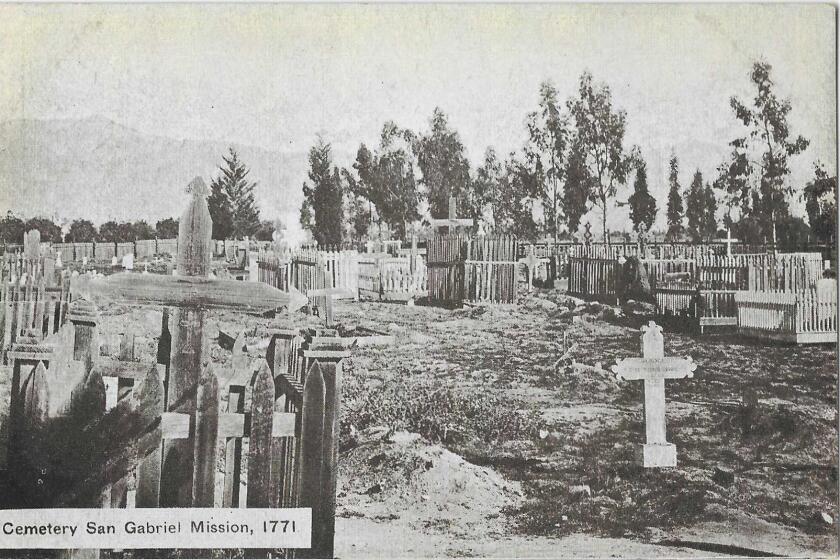 Black and white image shows crosses in a graveyard