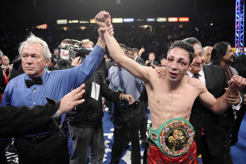 Referee Pat Russell raises the arm of Israel Vazquez of Mexico after he defeated Rafael Marquez of Mexico in their WBC super bantamweight championship bout, Saturday, March. 1, 2008 in Carson, Calif. Vazquez won in a split decision. (AP Photo/Mark J. Terrill)