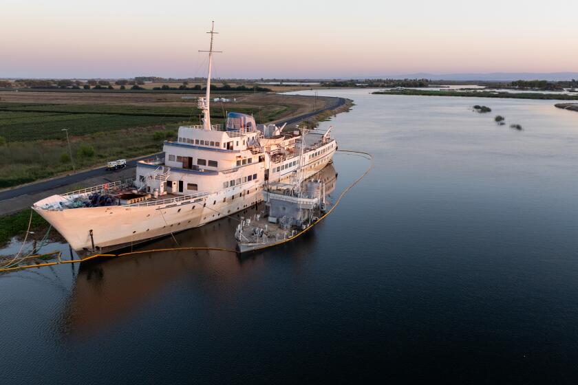 Stockton, CA - September 22: 'The Aurora,' left, which hasn't been operational in decades, is moored in Little Potato Slough in the delta on Sunday, Sept. 22, 2024 in Stockton, CA. (Brian van der Brug / Los Angeles Times)