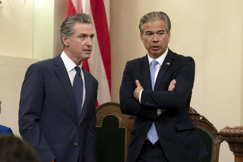 California Gov. Gavin Newsom, left, talks with California Attorney General Rob Bonta during the assembly's Organizational Session in Sacramento, Calif., Monday, Dec. 2, 2024. (AP Photo/Rich Pedroncelli, Pool)