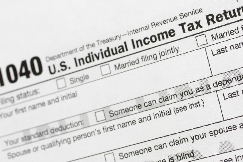 FILE - This July 24, 2018, file photo shows a portion of the 1040 U.S. Individual Income Tax Return form. It’s the time of year to start thinking about taxes - what's ahead and what can be done now to manage. But the upcoming tax filing season is going to be trickier for many Americans due to rampant unemployment, working from home and general upheaval due to COVID-19. (AP Photo/Mark Lennihan, File)