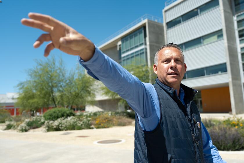 MERCED CA. MAY 3, 2023 - Adam Gray points to a former cow pasture and where the future medical education building will be built at UC Merced that he helped establish, Gray delivers lectures for the political science department at the university. Friday, May 3, 2024, in Merced, Calif. (Paul Kuroda / For The Times)