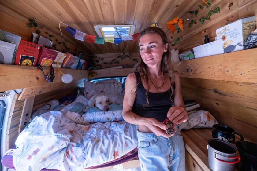 Bishop, CA - October 02: Emily Markstein lives in her van in the Inyo National Forest outside the Town of Mammoth Lakes. In the Eastern Sierra, there's vacant land for as far as the eye can see - and almost nowhere to live. All those empty acres are owned by conservation-minded government agencies, driving up prices on the few houses and condos that exist. That has led to an affordable housing crisis in the resort town of Mammoth Lakes, where ski lift operators and restaurant employees can't hope to compete with wealthy tourists for a place to lay their heads. The problem extends all the way down the mountain to the hard-scrabble ranching town of Bishop on Wednesday, Oct. 2, 2024 in Bishop, CA. (Brian van der Brug / Los Angeles Times)