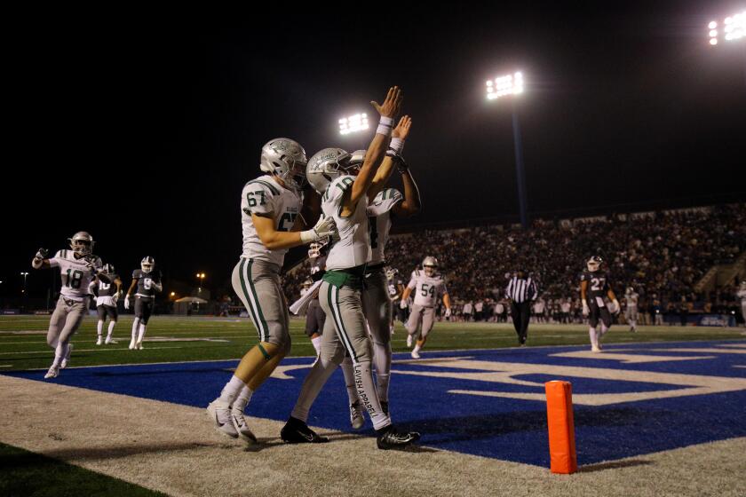 NORWALK, CA - DECEMBER 14, 2019: De La Salle quarterback Dorian Hale (10), middle, celebrates his touchdown against St John Bosco in the first half of the CIF state championship Open Division at Cerritos College on December 14, 2019 in Norwalk, California. (Gina Ferazzi/Los AngelesTimes)