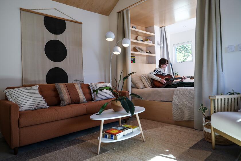 Glendale, CA, Monday, September 23, 2024 - Mason Stucker, 19, plays the guitar in the 533-square foot ADU behind his family's home in Glendale. Emily Mohr and Jonathan Rieke of MR Studio Architecture recently completed a beautiful and budget-friendly ADU in Glendale for lighting designer Kille Knobel who has worked for Pearl Jam and other bands. (Robert Gauthier/Los Angeles Times)