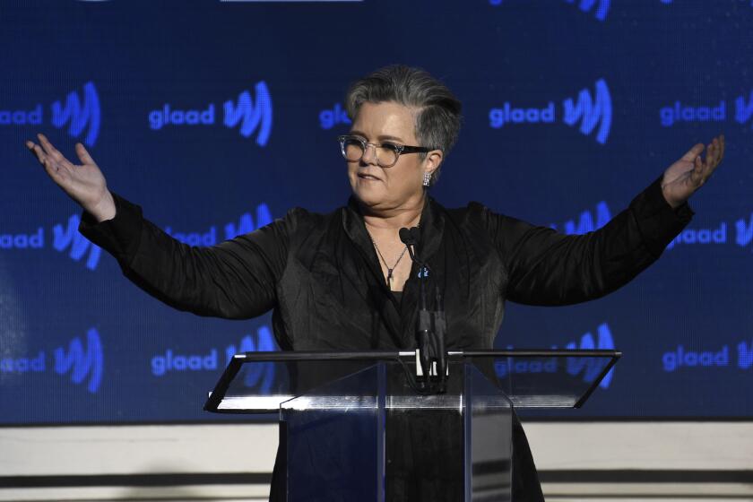 Rosie O'Donnell raises arms in black blazer during speech at the 2019 GLAAD Media Awards at the New York Hilton Midtown