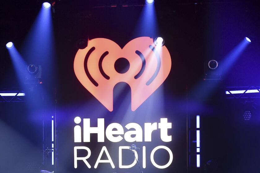 The iHeartRadio logo under spotlights on a stage